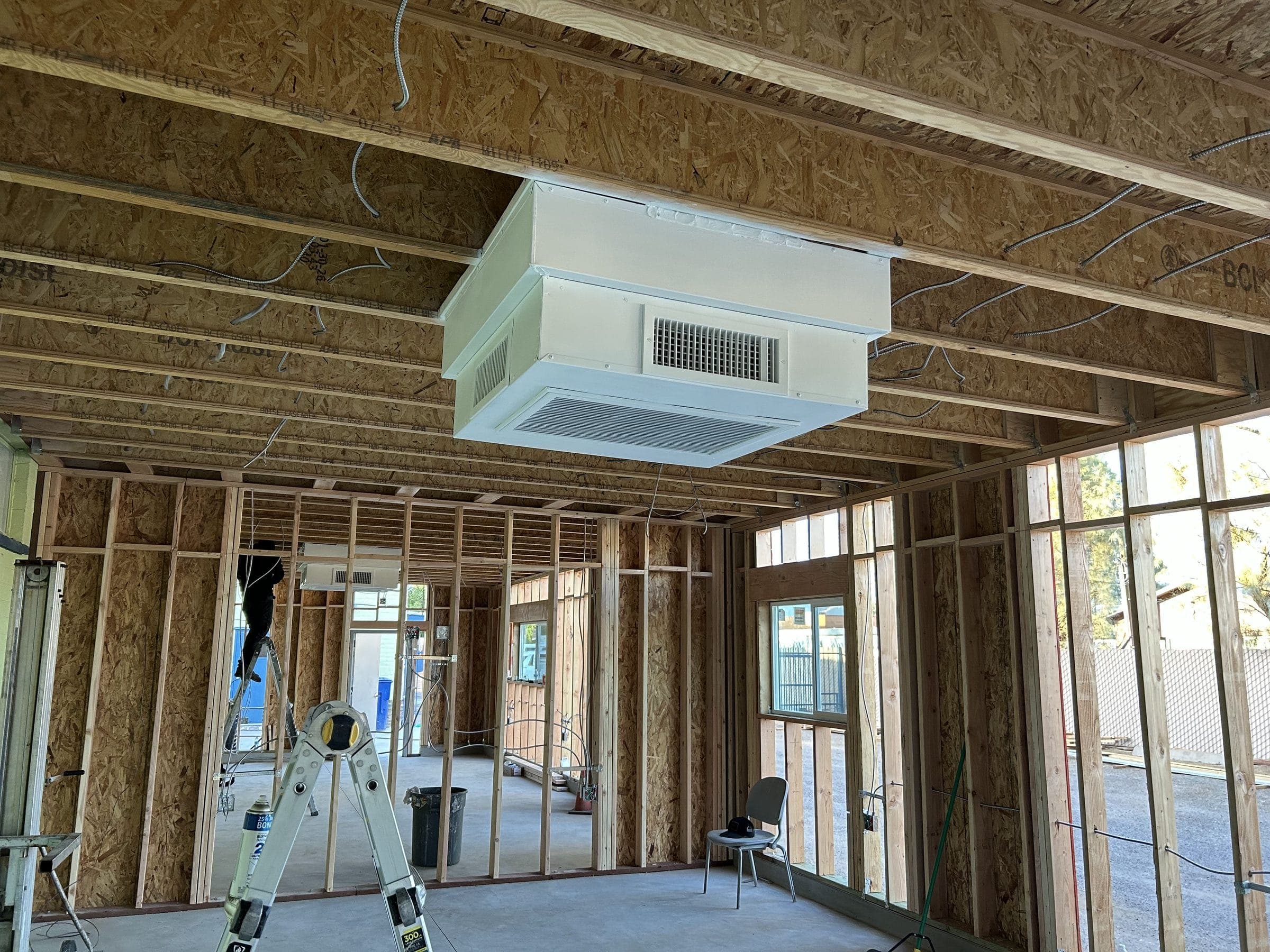 Ceiling-mounted HVAC unit installed in a commercial space under construction